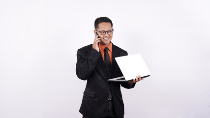 businessman holding a laptop computer while on the phone isolated white background