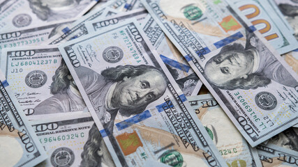 Scattering of hundred-dollar American securities on the table close-up