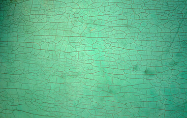 A blue-green pattern that fades along the wall, cracks background. 