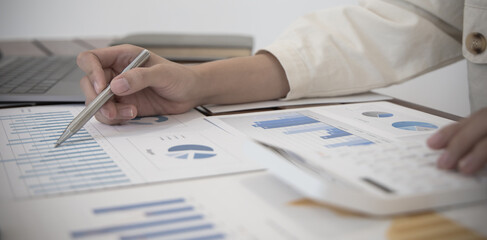 Naklejka premium Financial businesswomen analyze the graph of the company's performance to create profits and growth, Market research reports and income statistics, Financial and Accounting concept.