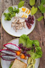 Dragon fruit, grape, whole wheat bread, boiled chicken breast and boiled egg, broccoli in a healthy vegetarian dish. 