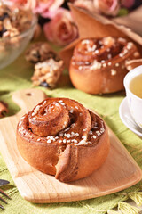 Freshly baked cinnamon roll dusted with powdered sugar