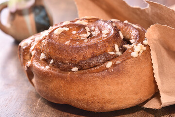 Freshly baked cinnamon roll dusted with powdered sugar