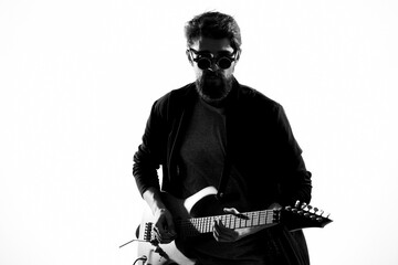 Cheerful male musician in leather jacket with sunglasses guitar performing