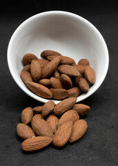 Unsalted almonds in a white bowl