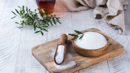 Fototapeta na wymiar Natural sweetener in a wooden spoon. Sugar substitute. Erythritol