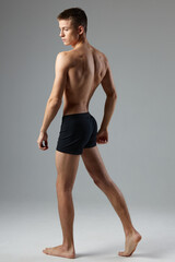 sporty man in black panties pumped up body posing lifestyle