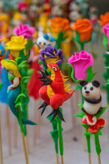 Fototapeta na wymiar Colorful tiny dough sculpture figurines - Chinese street art 