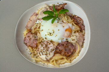 Italian food spaghetti carbonara that is decorated within plate beautifully and It is a popular food.