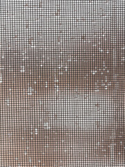 Raindrops on a mosquito net as a background.