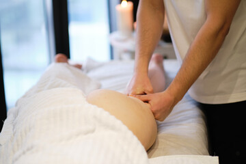 Obraz na płótnie Canvas masseur makes anticellulite massage young woman in the spa salon. Body care concept. Special anticellulite treatment.
