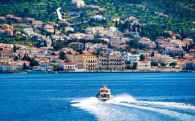 Fototapeta premium Small red motor boat transfer people to Spetses island, Greece