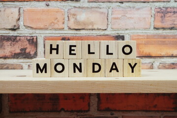 Fototapeta premium Hello Monday alphabet letter on shelves wooden background