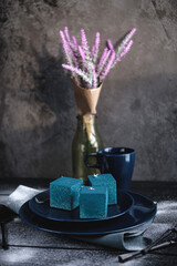 Blue cake filled with orange and tangerine in the shape of a cube. Rustic style.