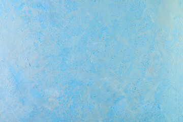 Fototapeta na wymiar Background texture of rough plaster with white splashes of blue