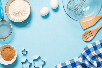 Culinary background with ingredients for baking on a light blue  concrete table. Top view with copy space.