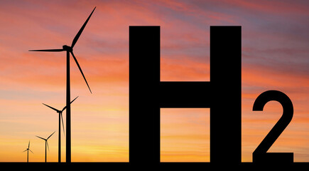 Silhouettes of Hydrogen symbol and wind turbines. Getting green hydrogen from renewable energy...