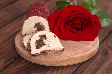 Eastern sweetness halva with chocolate and rose on wooden background
