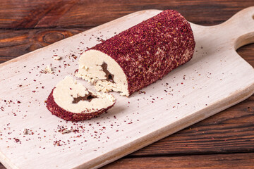Eastern sweet halva with chocolate and rose powder on wooden background.