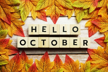 Naklejka na ściany i meble Happy October alphabet letter with maple leaves decoration on wooden background