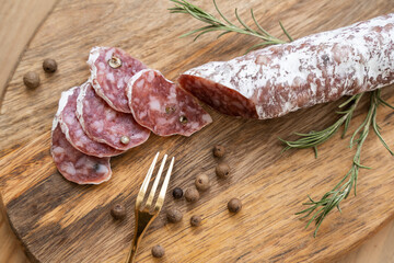 Iberian chorizo, Spanish chorizo or Spanish sausage cut into slices on a wooden board
