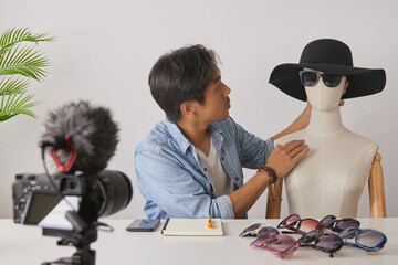 Asian Vlogger or Blogger Put Fashion Glasses to The Face of Mannequins and Recording Video....