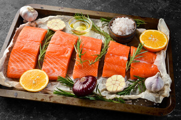 Cooking Salmon with rosemary, lemon and vegetables. Recipe. Seafood. Top view. Free space for text.