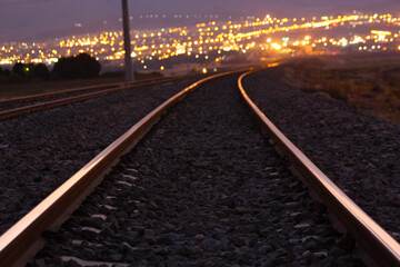 railway near city at night 