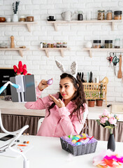 Funny woman greeting her friends online, celebrating easter