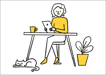 机でタブレットを見ている女性