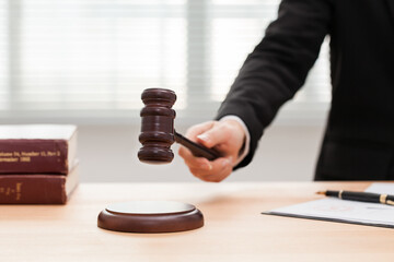 legal law, advice and justice concept, counseling lawyer holding a gavel striking on working desk.