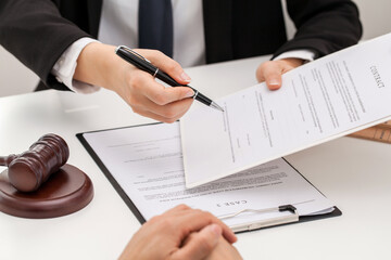 attorney lawyer counseling and giving advice to customer to sign papers in office.  justice advice concept.