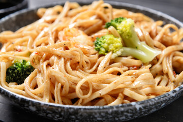 Plate with tasty noodles and seafood, closeup