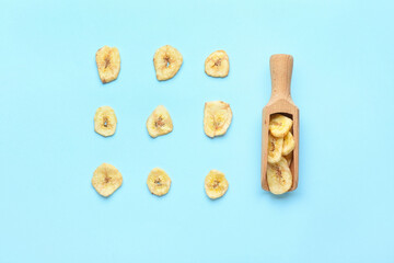 Fototapeta na wymiar Crispy banana chips on color background