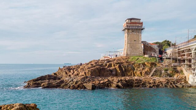Livorno, Tuscany, Italy: Beach and cliffs of calafuria. The tower indicates the cliff under the Aurelia bridge: a beautiful sea, a classic diving destination. CINEMA RAW FOOTAGE