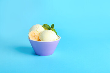 Tasty banana ice-cream in bowl on color background