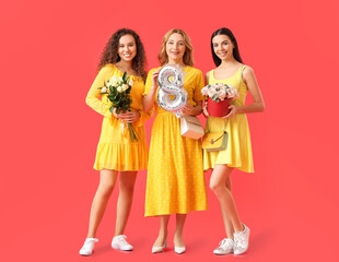 Beautiful women with flowers and balloon on color background. International Women's Day celebration