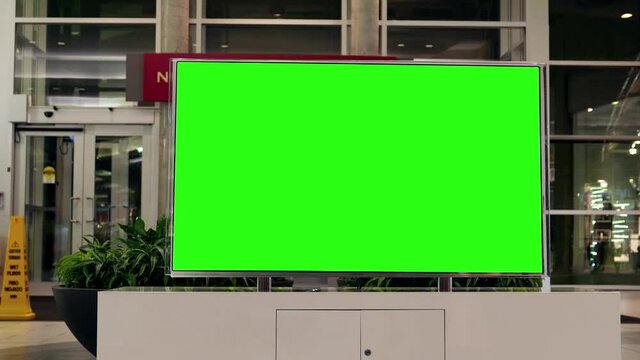 Display tv with the green screen inside Coquitlam shopping mall entrance with 4k resolution