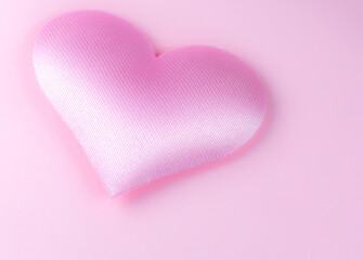 Obraz premium Pink heart on pink background. Saint Valentine's day concept. Love and romantic photo. Postcard for holiday. Beautiful warm wallpaper with love. Soft focus. Copy space.