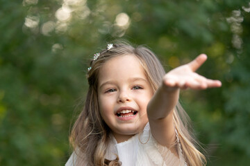 Cute child girl need help and pulling hand arm reach out to camera.