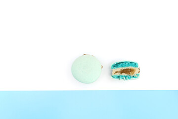 Tasty blue french macarons or macaroons on a white and blue background. Place for text. color geometry