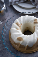 Pudding. Cottage cheese coffee chocolate dessert. Jelly. White cupcake on the table. Sweet pudding is round with a hole in the center. Still life on the table. Breakfast
