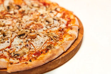 Fresh pizza with bacon, mushrooms and cheese on a light background. Close-up, selective focus