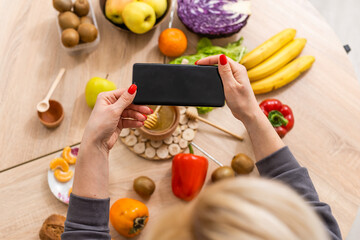 Woman using calorie counter application on her smartphone