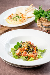 Eggplant salad in white plate filmed for menu