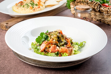 Eggplant salad in white plate filmed for menu