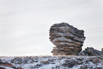 Weathering pillar on the Oltrek island. Winter