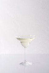 Vermouth in a cocktail glass on a gray background, slightly alcoholic drink