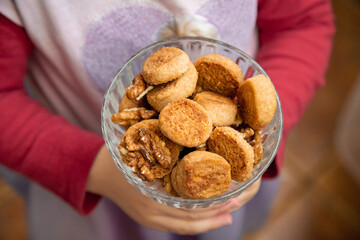 Children's hands hold a bowl of homemade cookies