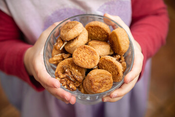 Children's hands hold a bowl of homemade cookies